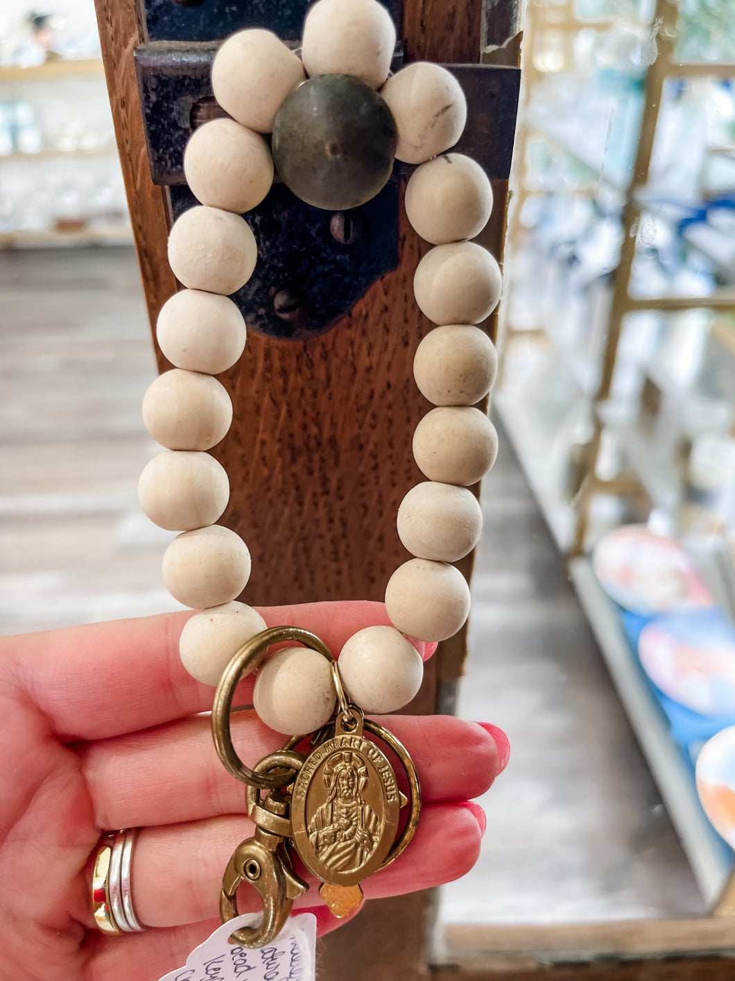 Smaller natural wood bead wristlet keychain with crucifix and sacred heart of Jesus-Stretched Out Designs By Chelse Breaux