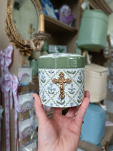 Load image into Gallery viewer, Crucifix on green/blue floral canister- Christina Yeager Designs
