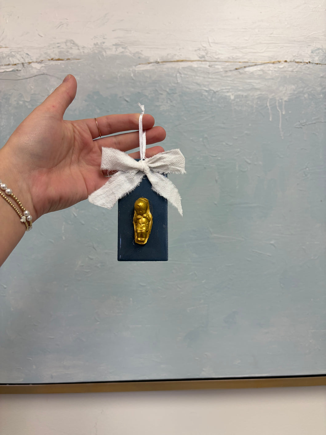 Gold baby on blue back ornament - Grace and Mercy Co