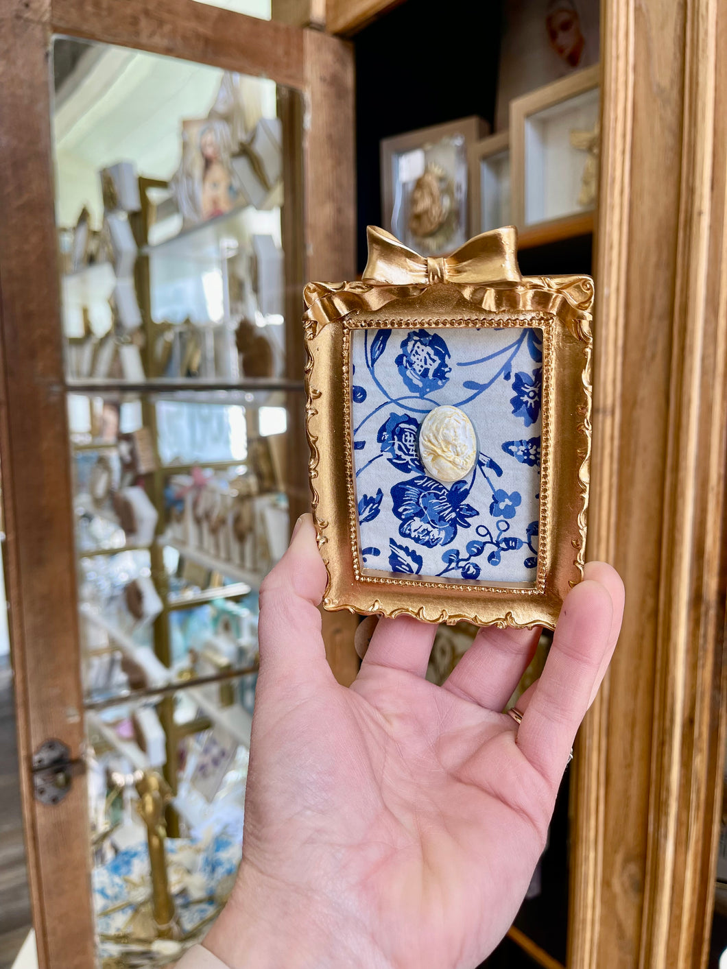 Floral backed gold bow framed religious medals - Stella Maris Designs by Lauren Bramble