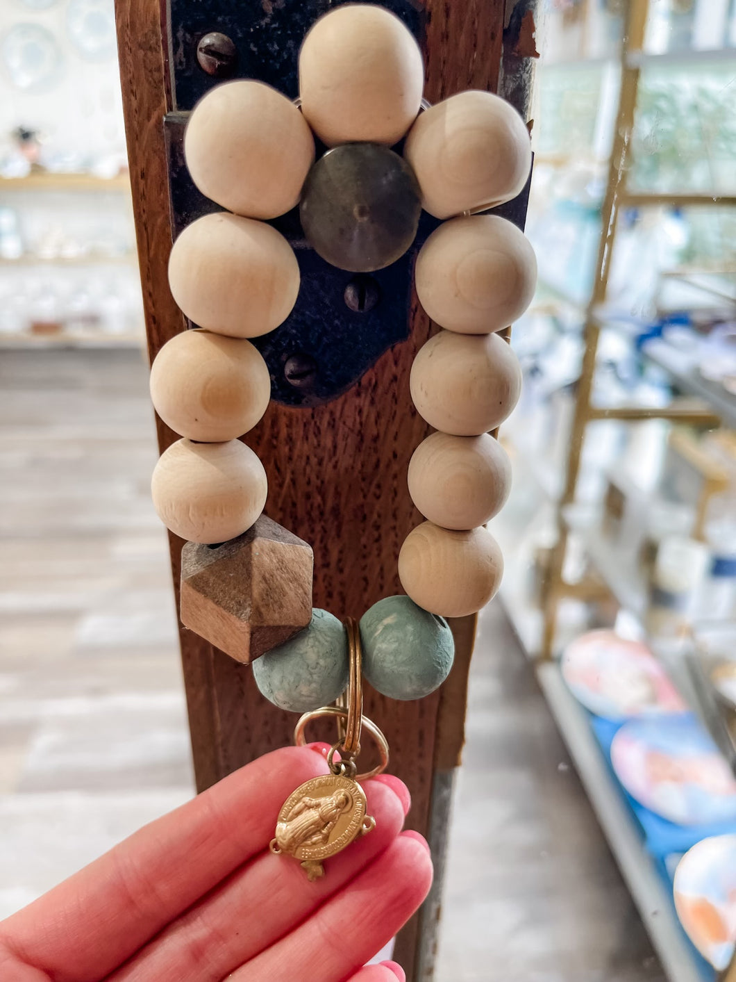Natural wood, green, and dark wood bead wristlet keychain with crucifix and mary-Stretched Out Designs By Chelse Breaux